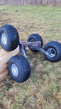 two large tires are attached to a wooden trailer