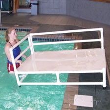 a woman in a swimming pool with a life guard chair