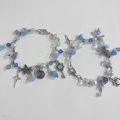 two bracelets that have charms on them