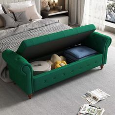 a green couch sitting on top of a white carpeted floor next to a bed