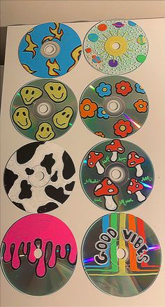 six cd's with different designs on them