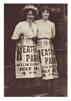 two women in aprons standing next to each other