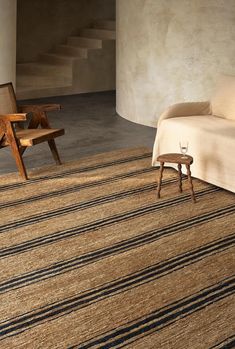 a living room with a couch, chair and rug