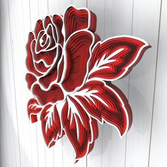 a paper cut out of a red rose on a white wooden wall with wood planks