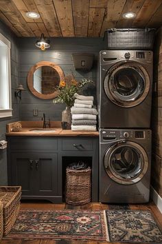 a washer and dryer in a small room with wood paneling on the walls