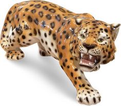 a ceramic figurine of a leopard laying down