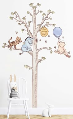 the winnie the pooh tree wall decal is shown in this children's room