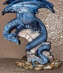 a blue dragon statue sitting on top of a table