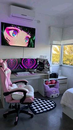 a room with a desk, chair and computer monitor on the wall above it is a checkered rug