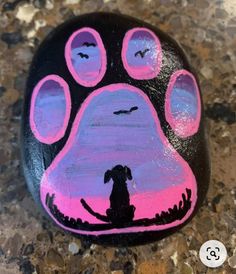 a painted rock with a dog's paw on it