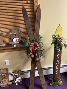 two wooden skis with decorations on them in front of a window and purple carpet