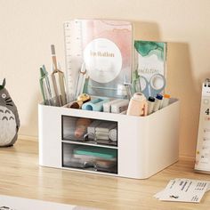 an organized desk with pens, pencils and markers