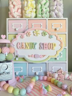 a candy shop display with pastel colors and lots of candies on the counter