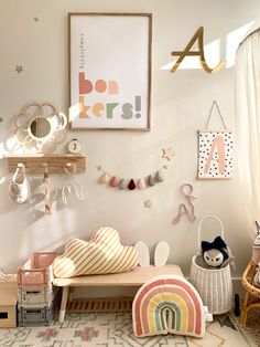 a child's room with toys and decor on the wall, including a bench