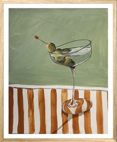 a painting of a martini glass with olives in it on a striped tablecloth