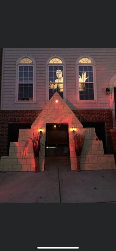 the front of a building with lights on it