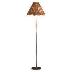 a floor lamp with a brown shade on it's base and a white background