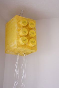 a yellow light fixture hanging from the ceiling