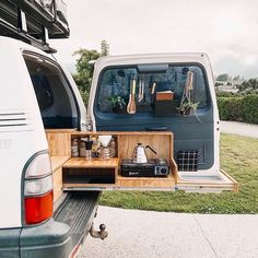 the back end of a van with an open trunk and shelves on it's side