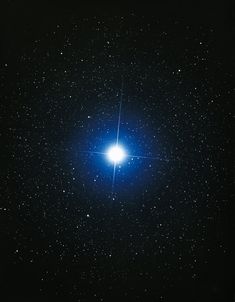 the bright blue star is shining brightly in the dark sky