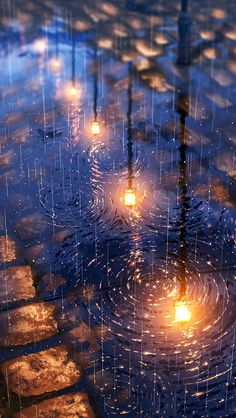 the rain is falling down and there are candles in the water