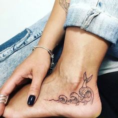 a woman's foot with a rabbit tattoo on the top and bottom of it