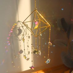 the sun shines brightly on a mobile with jewels hanging from it