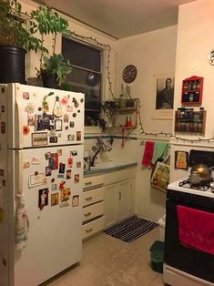 a white refrigerator freezer sitting inside of a kitchen next to a stove top oven