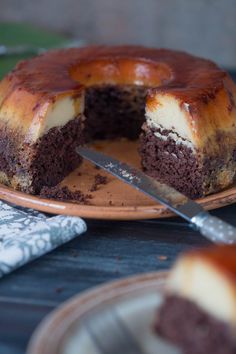 a chocolate cake on a plate with a knife