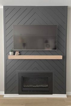 a living room with a fireplace and tv mounted on the wall above it's mantle