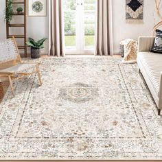 a living room filled with furniture and a rug on top of a hard wood floor