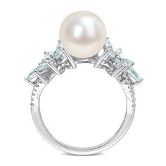 Bursting with wintry colour and floral charm, this beautiful freshwater cultured pearl, blue aquamarine and diamond ring is destined to delight. Fashioned in 14K white gold This look features a lustrous 9.0-9.5mm round freshwater cultured pearl. Flanking the centre, vibrant flower designs glisten with multi-sized marquise-cut and round icy-blue aquamarines. The diamond-touched split shank adds a touch of sparkle. This ring shines with 0.13 ct. t..w of diamonds. Jared The Galleria Of Jewelry, Peoples Jewellers, Aquamarine Stone, Pearl Types, Diamond Flower, Aquamarine Rings, Natural Aquamarine, Flower Ring, Rings For Her