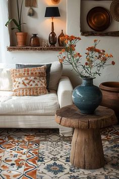 a living room filled with lots of furniture and flowers on top of a wooden table