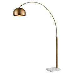 an arc floor lamp with a marble base and gold colored shade on the top part of it