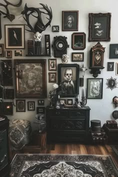 a room filled with lots of framed pictures and deer heads on the wall above it