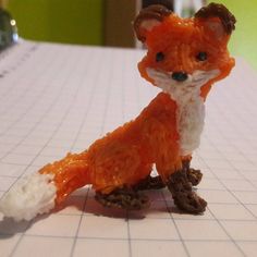 a toy fox sitting on top of a table