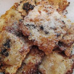 some kind of food on a plate with powdered sugar and seasoning sprinkles