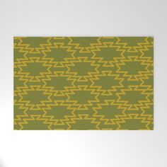 a yellow and green pattern on a white wall