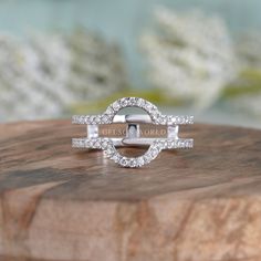 a diamond ring sitting on top of a wooden block with the words love you more written in it