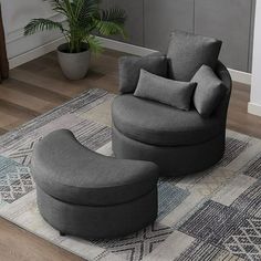 a living room with a chair and ottoman on the floor next to a potted plant