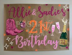 a birthday sign with cowboy boots and wine glasses on it's brown paper bag