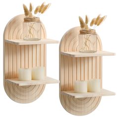 two wooden shelves with candles and vases on them