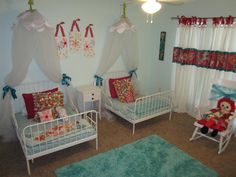 two white beds in a room with curtains on the windows and rugs on the floor