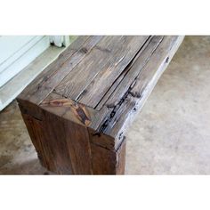 an old wooden bench sitting on top of a cement floor