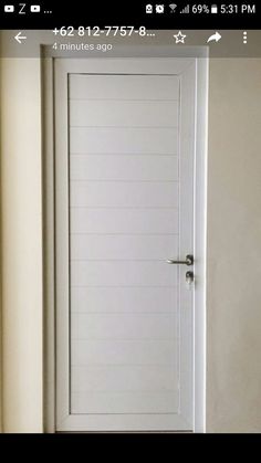 an open door in the corner of a room with white walls and flooring on it