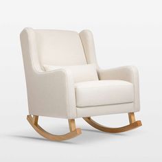 an upholstered rocking chair with wooden legs and white fabric, on a plain background