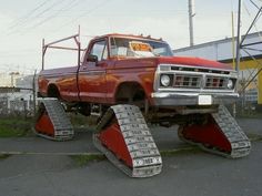 an old red truck with snow plow tires