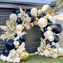 the balloon arch is decorated with gold, white and blue balloons