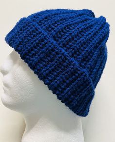 a white mannequin head wearing a blue knitted hat