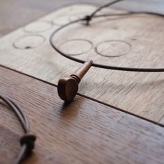 a close up of a piece of wood with a wooden object on it's side